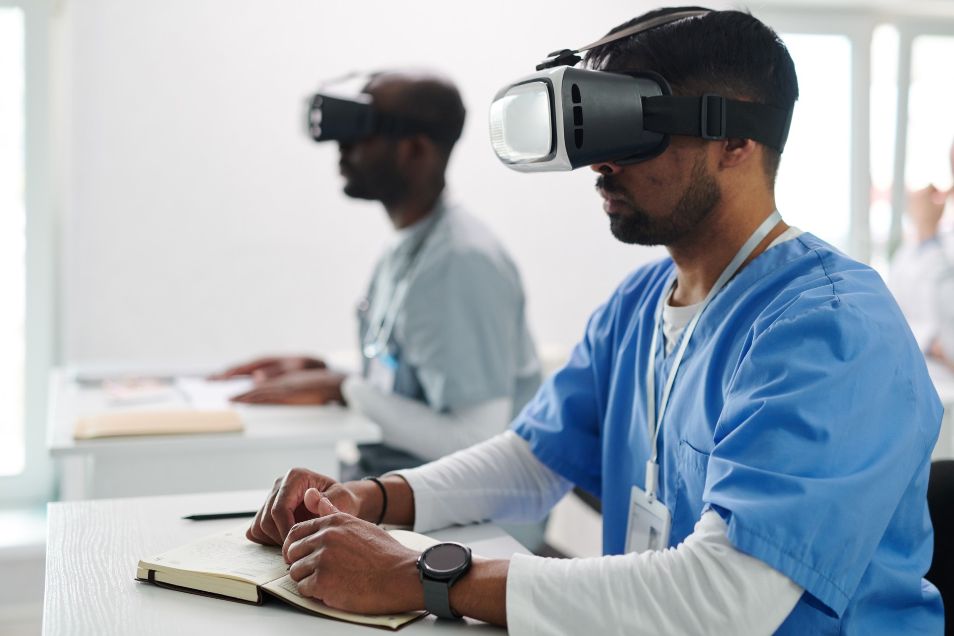 Students in VR goggles studying medicine virtually